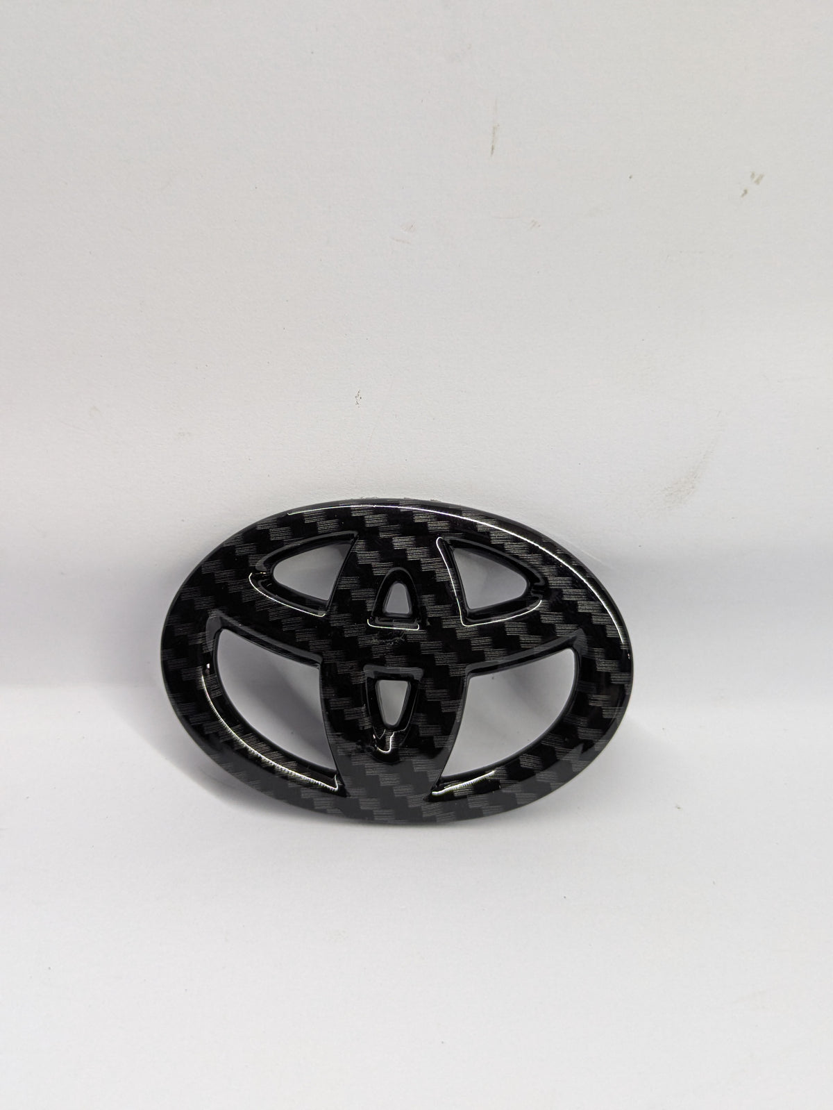 Toyota carbon steering logo